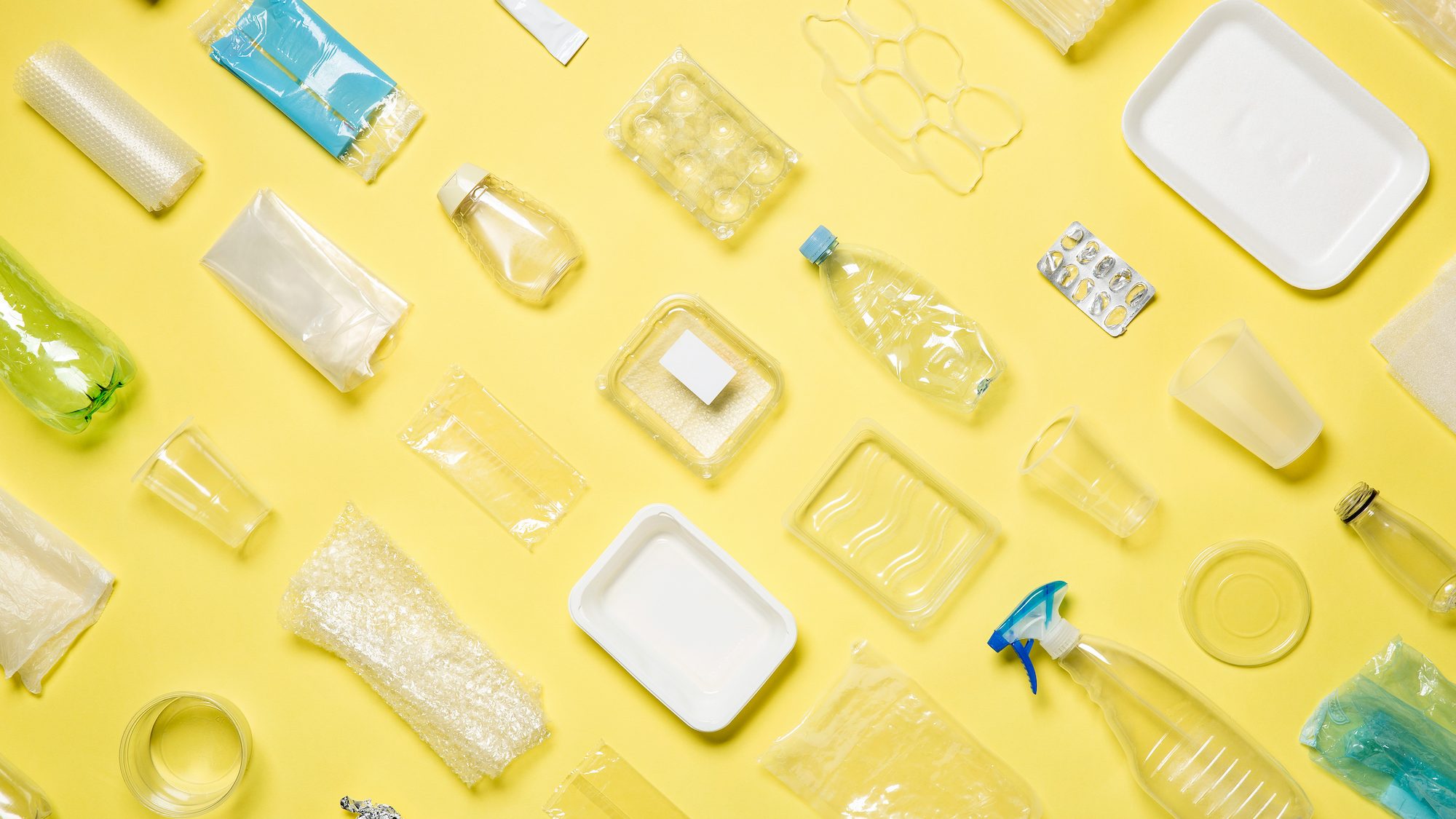 Different,Types,Of,Used,Plastic,Packaging,Arranged,On,A,Yellow